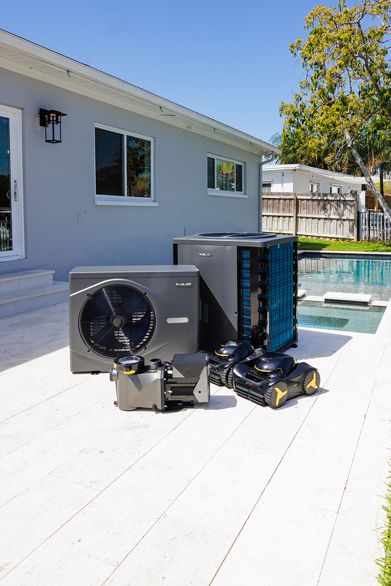 SunBlazer heater, heat/cool pump, pump, and robotic pool cleaners next to a swimming pool