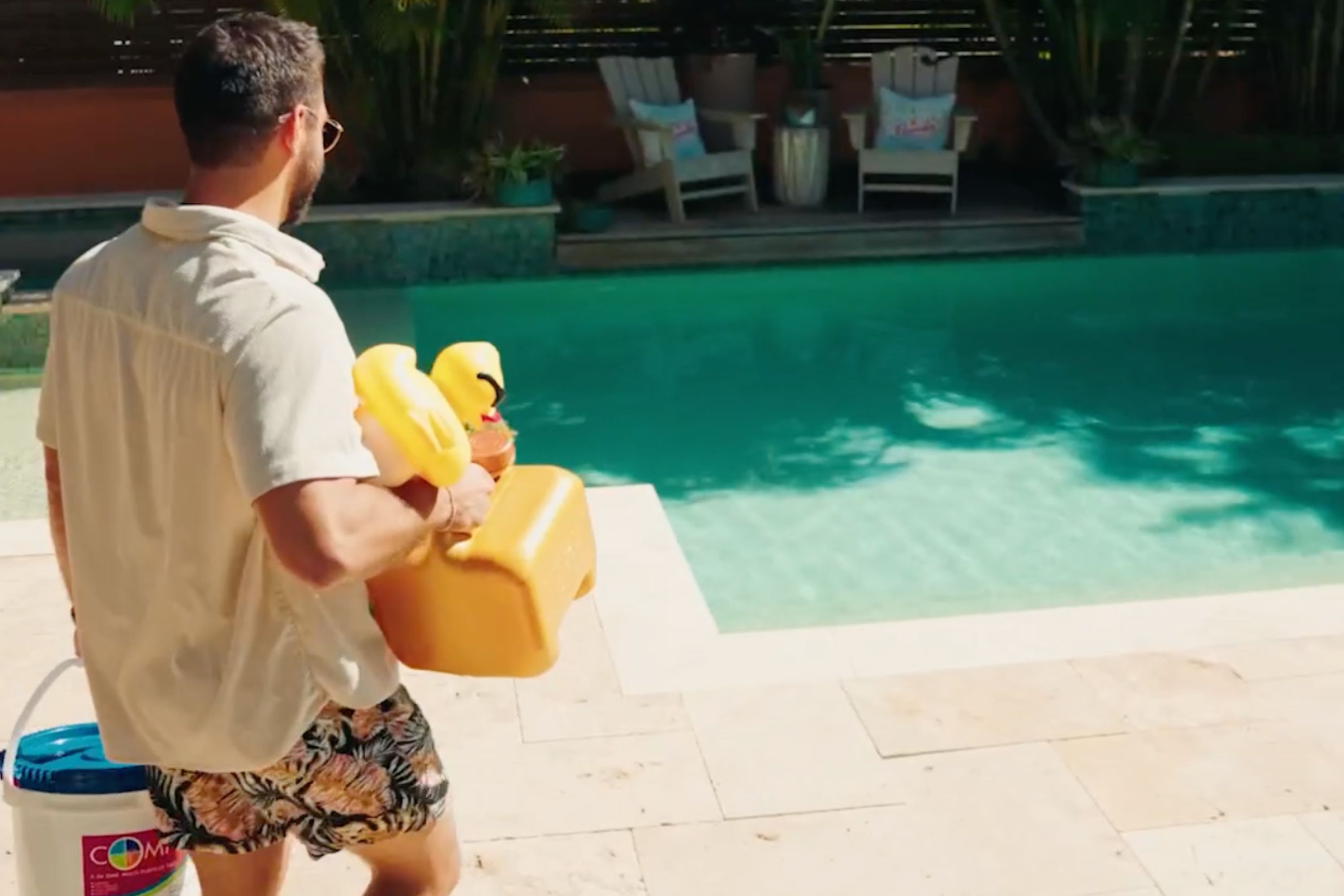 Man with pool cleaning equipment