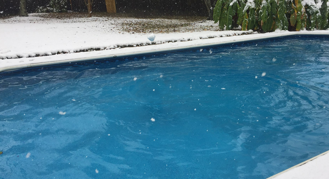 pool with snow falling